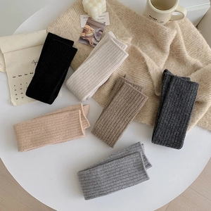 Detailed knit texture of thick wool socks in six neutral colors for winter warmth