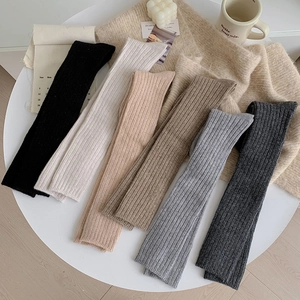 Detailed knit ribbed wool socks in six colors arranged on a minimalist white table