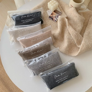 Detail of five-color thick wool knit socks set in premium zipper packaging bags