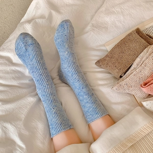 Blue speckled wool socks in soft ribbed knit shown on feet for cozy winter warmth