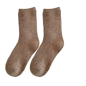 Brown thick wool socks with vertical ribbing pattern on a clean white background