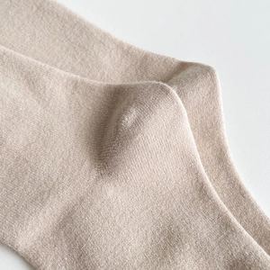Detailed macro view of the premium beige knit texture and durable high-density fabric