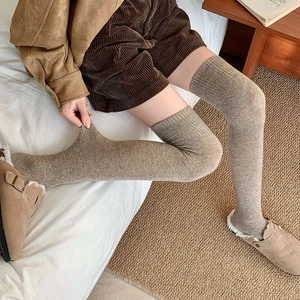 Elastic ribbed knit over-knee socks in oatmeal brown showing high stretch fabric