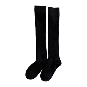 Thick wool calf socks for women in black ribbed knit with a cozy minimalist design