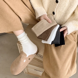 Detailed knit ribbed texture of women's mid-calf socks in diverse autumn color options