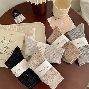 Thick wool blend nep yarn socks in various colors with textured knit and paper packaging