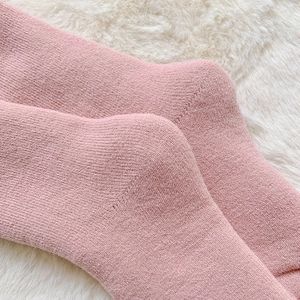 Close-up of pink thermal winter sock showing detailed knit texture on soft faux fur