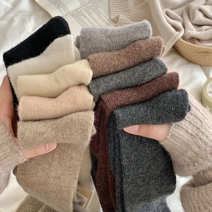 Detailed knit texture of thick winter over-knee socks in various solid neutral colors