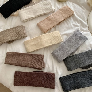 Thick knitted over-knee socks in various solid colors showing warm ribbed texture details