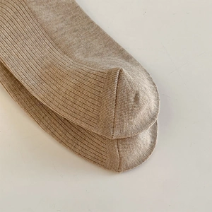 Detailed close-up of khaki ribbed cotton blend socks showing seamless heel and toe stitching