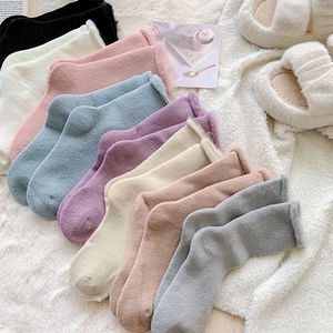 Close-up of thick winter socks in various Morandi colors with warm fleece lining
