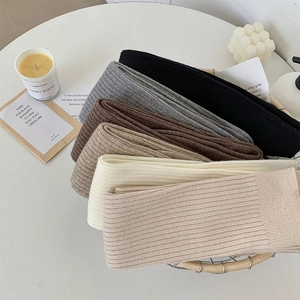 Close-up of ribbed knit over-the-knee socks in six neutral colors for winter warmth
