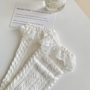 Detail of white Lolita lace trim socks featuring vertical ribbed knit and ruffled edges