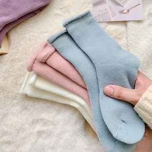 Detail showing plush knitted texture and soft Morandi colors of thick winter thermal socks