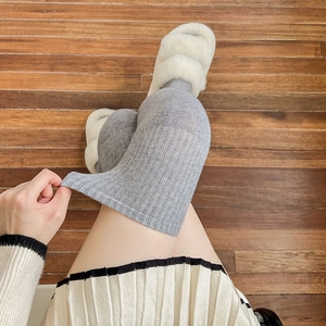 Detailed texture of gray ribbed knit over-the-knee wool socks for winter warmth
