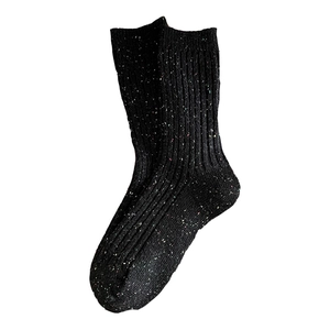 Thick black wool blend crew socks with colorful tweed flecks and ribbed texture for winter