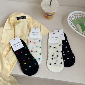 Detail view of four-pair colorful polka dot mesh boat socks with breathable mesh texture
