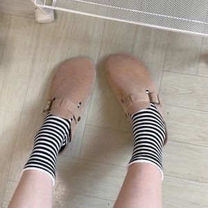 Japanese style khaki suede clogs with adjustable buckle worn with striped cotton socks