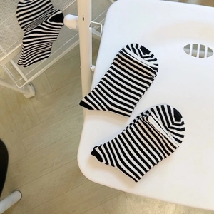 Classic black and white striped crew socks for women featuring minimalist cotton knit style