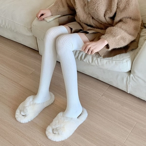 Detailed view of white ribbed knit over-the-knee socks with soft elastic texture