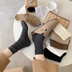 Detailed texture of ribbed mid-calf cotton socks in gray and assorted neutral colors