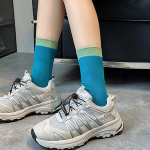 Blue patchwork mid-calf sports socks paired with retro thick-soled sneakers for women