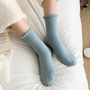 Thick light blue thermal crew socks with ribbed knit pattern and plush fleece cuffs