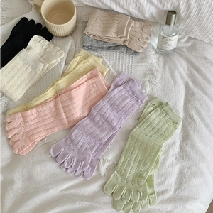 Close-up of pastel cotton five-finger socks with breathable hollow mesh texture