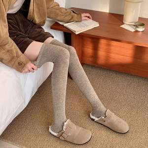 Warm oatmeal-colored cable knit over-knee socks featuring vertical ribbed texture for women