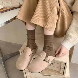 Beige suede clogs paired with deep coffee ribbed mid-calf socks for autumn outfits