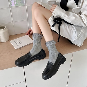Grey Lolita style lace trim socks with ribbed texture paired with black leather loafers