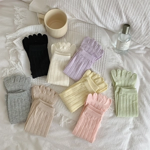 Detailed view of hollow mesh five-finger socks in various pastel macaron colors