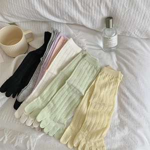 Detail showing breathable mesh hollow-out texture on pastel five-finger toe socks
