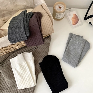 Detailed view of six colors of ribbed cotton mid-calf socks with vertical textures