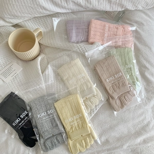 Detailed view of hollow-out mesh five-finger socks in multiple colors with packaging