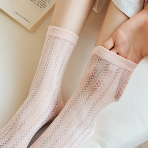Detail of pink plaid mesh socks with breathable grid texture and ribbed cuffs