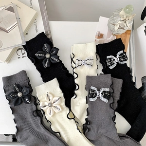 Detail of JK style knit socks with ruffle trim and 3D floral bow embellishments