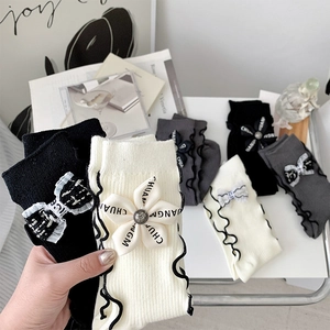 Elegant floral bow socks with ruffled edges in black, white and grey colors