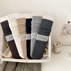 Close-up of 6 pairs of ribbed cotton socks in neutral tones with minimalist packaging