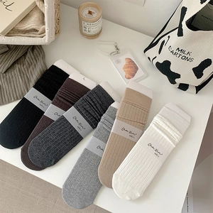 Pack of 6 solid color ribbed crew socks in assorted neutral tones like grey and beige