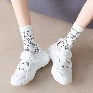 White platform sneakers with velcro straps and cute cartoon cat pattern mid-calf socks