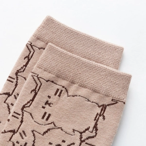 Detailed close-up of ribbed cuffs and cute brown cat pattern on khaki cotton socks