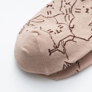 Close-up of khaki cotton knitted socks with cute brown cat embroidery and seamless toe