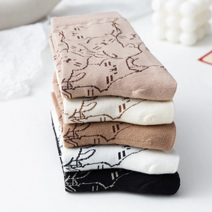 Detailed close-up of colorful cotton socks with cute cat jacquard patterns in five colors