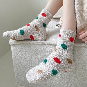 Detail of coral fleece winter socks with thick thermal texture and colorful polka dots