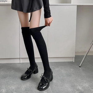 Black over-knee ribbed socks with high elasticity shown in college style outfit