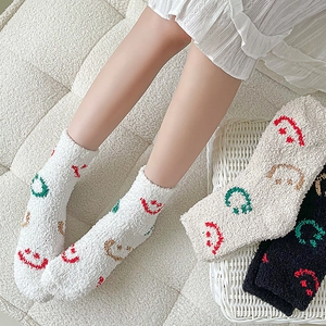 Thick coral fleece socks with colorful smiley faces and soft plush texture