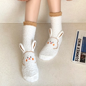 Detail of white coral fleece socks featuring 3D bunny ears and cute embroidery