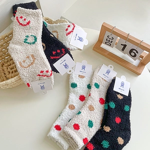 Detail of coral fleece winter socks with cute smile embroidery and soft fluffy texture