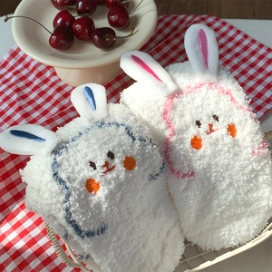 Close-up of fuzzy coral fleece socks with 3D bunny ears and cute animal embroidery